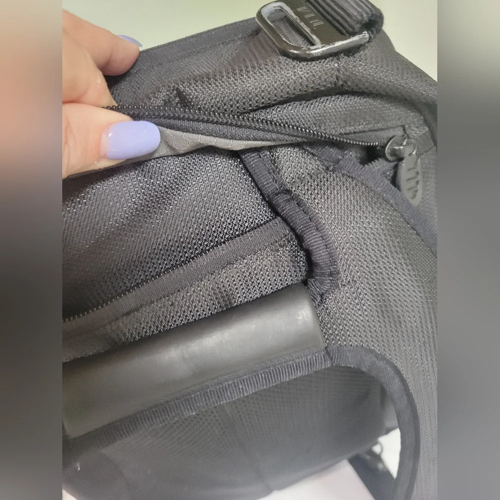 TUMI Black Backpack with Padded Straps and Multiple Compartments